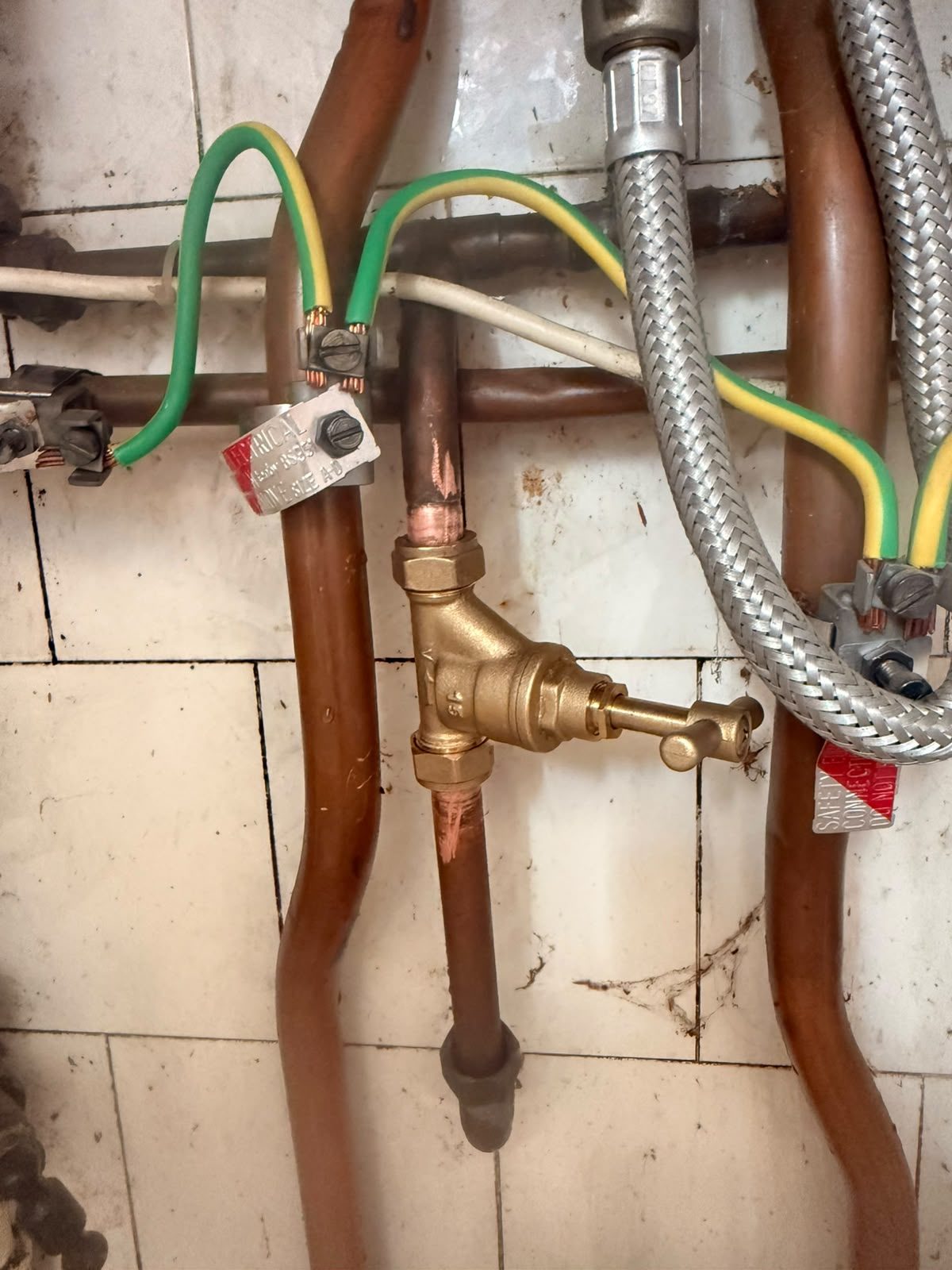 Central heating drain-off valve and copper pipework fitted during a heating system installation