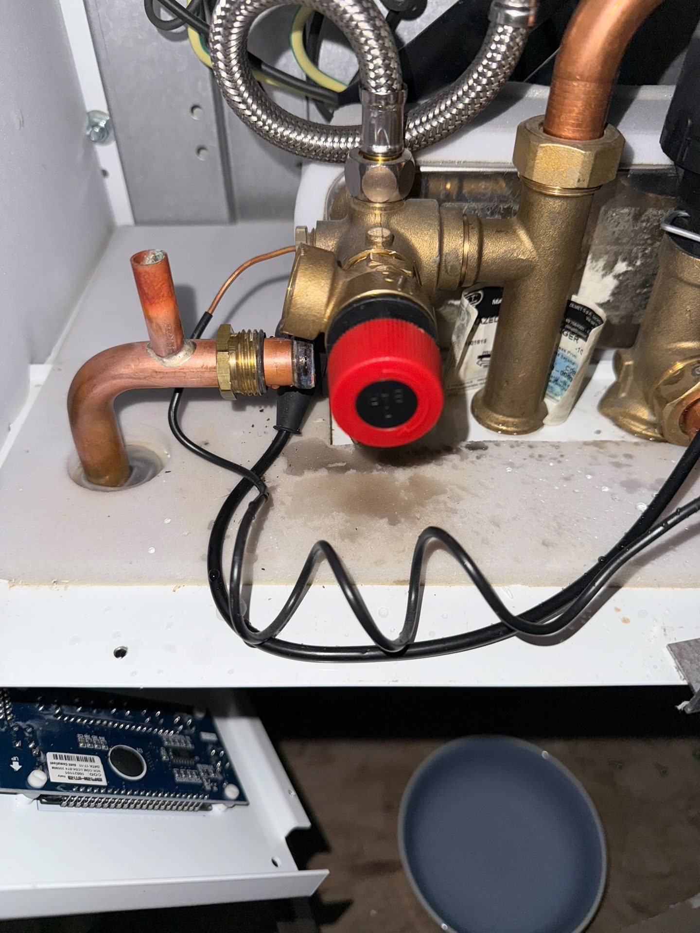 Inside a gas boiler showing brass valves and copper pipework during a Gas Safe boiler repair
