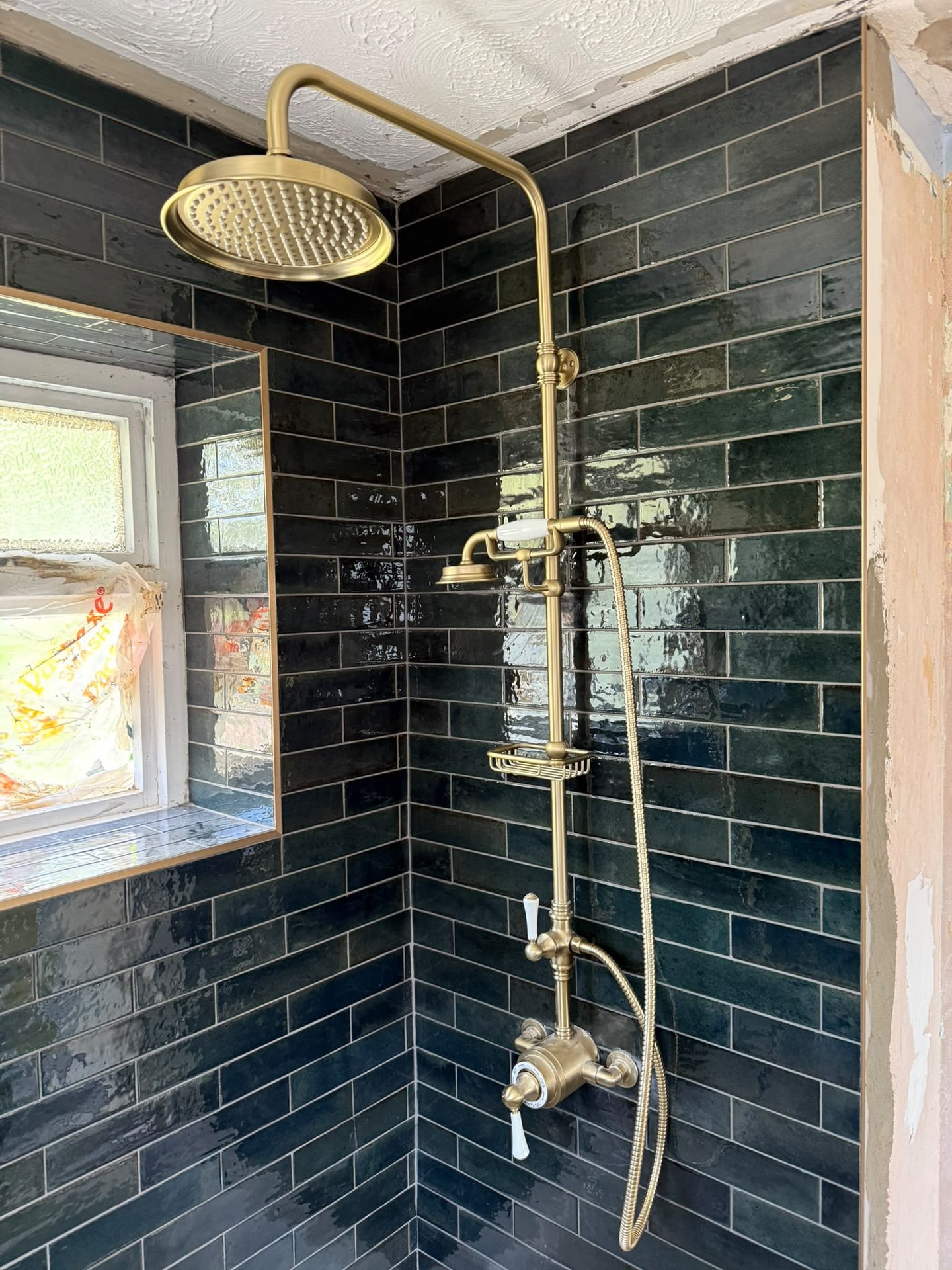 Completed shower installation with marble-effect tiling